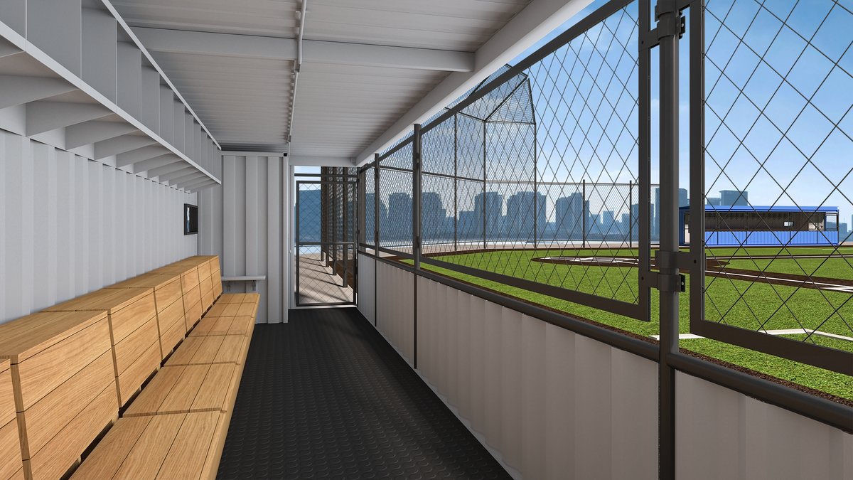 TeamBox interior view from player perspective showing bench seating, rubber flooring, wire mesh, and field view